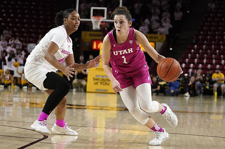 Utah's Issy Palmer (1) drives to the basket around Arizona State's Isadora Sousa, left, during an NCAA college basketball game, Sunday, Feb. 19, 2023, in Tempe, Ariz. (Darryl Webb/AP)