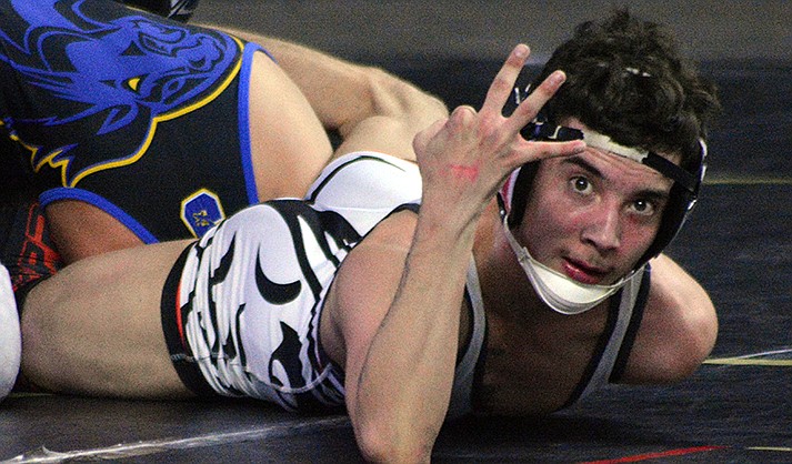 Mingus senior Brody Townsend signals his third gold medal at the state wrestling championships Feb. 18, 2023. (VVN/Raquel Hendrickson)