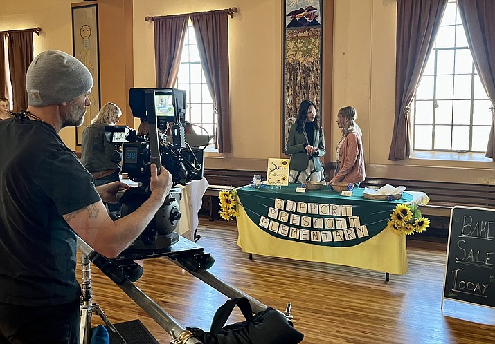 Members of the cast of the movie “Mysteries of the Heart” perform a school bake sale scene at the First Congregational Church on Gurley Street in downtown Prescott during filming on Friday, March 3, 2023. The movie cast and crew have been filming in Prescott since Feb. 23. (Cindy Barks/Courier)