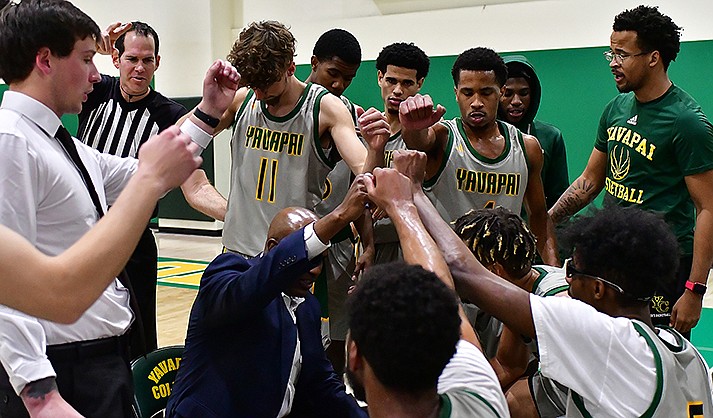 The Yavapai Community College men’s basketball team huddles around coach Jay Joyner. The players have had to rely on each other in a season that saw basketball back at the school for first time since 2011. (Photo courtesy of Chris Henstra/Yavapai Athletics)