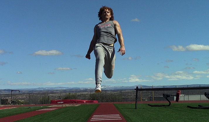 Brasen Durkalec flying through the air during the long jump (Photo by Ashtyn Labrie)