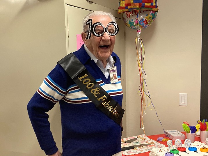 World War II decorated French Resistance fighter Santé Ceolin, who is also a longtime Sacred Heart Roman Catholic Church parishioner and St. Vincent de Paul volunteer, wears his party regalia to celebrate his 100th birthday March 2, 2023. (Nanci Hutson/Courier)