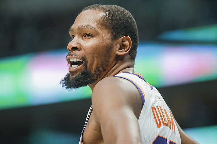 Phoenix Suns forward Kevin Durant interacts with a fan during the first half of an NBA basketball game against the Dallas Mavericks, Sunday, March 5, 2023, in Dallas. (Gareth Patterson/AP)