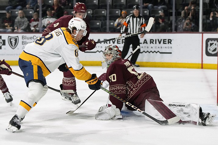 Arizona Coyotes goalie Ivan Prosvetov makes a save on Nashville Predators center Cody Glass (8) during the third period of a game Thursday, March 9, 2023, in Tempe, Ariz. The Coyotes won 4-1. (Rick Scuteri/AP)