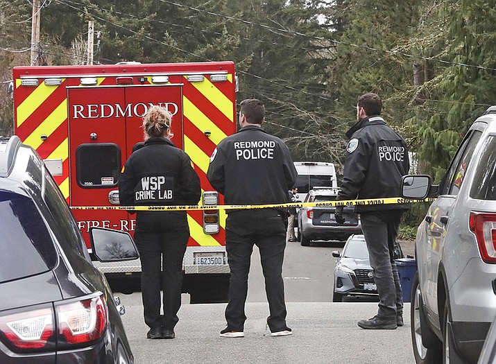 Police gather at NE 89th Street in Redmond, Wash., on Friday, March 10, 2023, after a suspected stalker killed a couple in their home before killing himself. (Greg Gilbert/The Seattle Times via AP)