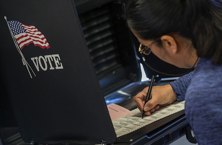 A woman marks her ballot at a polling center in the South Valley area of Albuquerque, N.M., Nov. 8, 2022. A Democratic-sponsored voting rights bill aimed at expanding access to the ballot in New Mexico won state Senate approval Wednesday, March 8, 2023. (AP Photo/Andres Leighton,File)