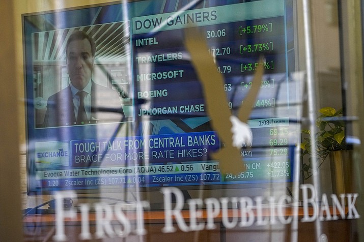A television screen displaying financial news is seen inside one of First Republic Bank's branches in the Financial District of Manhattan, Thursday, March 16, 2023. The S&P 500 was 0.8% higher in midday trading after erasing an earlier loss of nearly that much following reports that First Republic Bank could receive financial assistance or sell itself to another bank. (Mary Altaffer/AP)