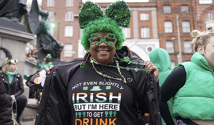 Torianna Fletcher from Detroit poses for a photo ahead of the St Patrick's Day Parade in Dublin, Friday March 17, 2023. (Brian Lawless/PA via AP)