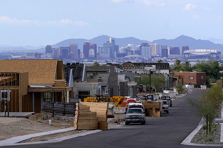 With the downtown skyline in the background, a new housing development adds to the expansive urban sprawl continuing to grow, Thursday, Aug. 12, 2021, in Phoenix. According to data released Thursday by the U.S. Census Bureau Phoenix was the fastest-growing big city in the United States between 2010 and 2020 as it added 163,000 more residents. (Ross D. Franklin/AP)