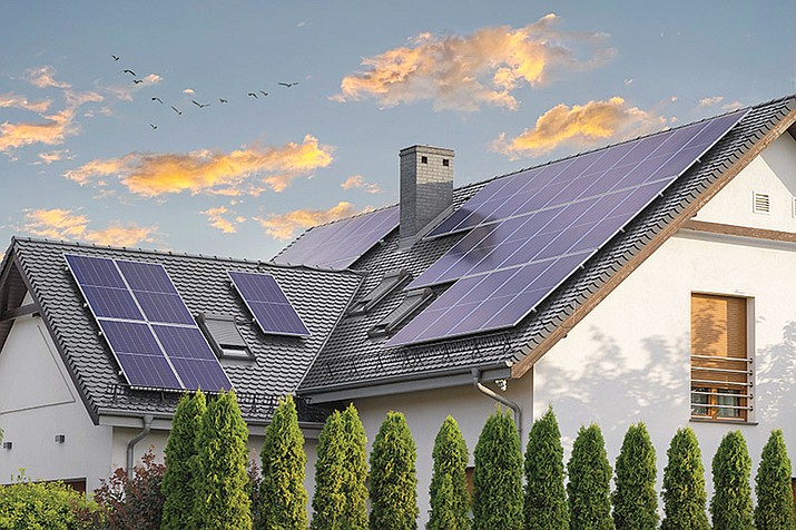 A large modern house is seen with solar panels on a pitched roof. (Solar United Neighbors/Courtesy)