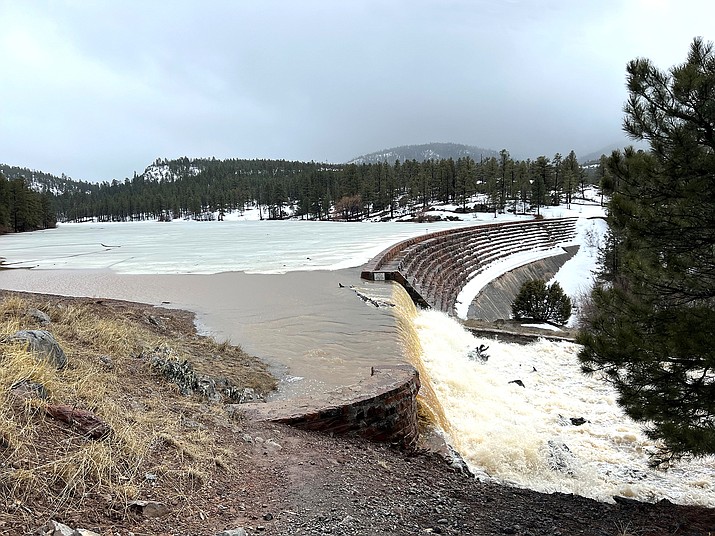 Santa Fe Reservoir is at capacity, with overflow pouring over the spillway March 15. With over 100 inches of snow and two days of rain, flooding was seen on some roadways in Williams, with significant impacts in the Verde Valley. (Wendy Howell/WGCN)