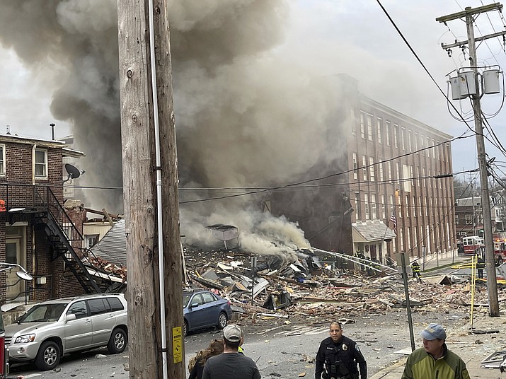 Emergency personnel work at the site of a deadly explosion at a chocolate factory in West Reading, Pa., Friday, March 24, 2023. (Ben Hasty /Reading Eagle via AP)