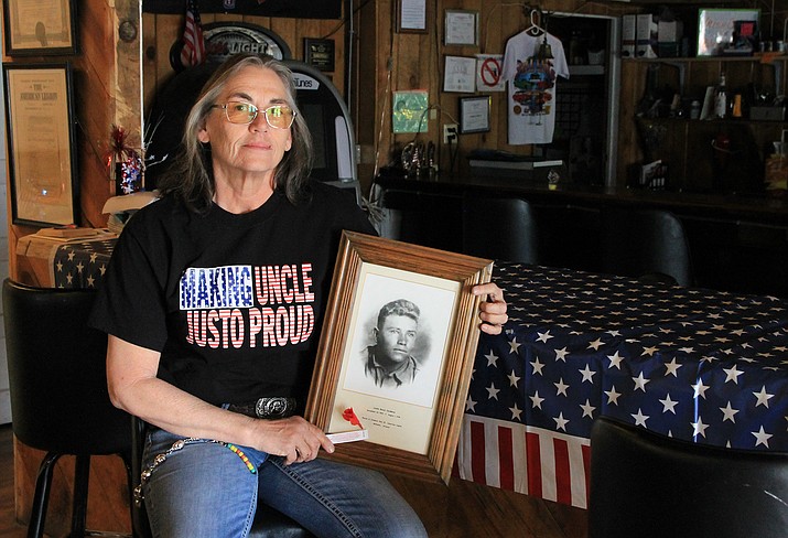 "Making Uncle Justo Proud," reads Harwood's shirt. Taking a seat at the Cordova Post 13, the new commander proudly displays a picture of her great uncle. (Summer Serino/WGCN)