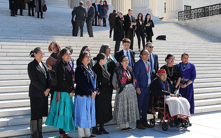 Navajo President Buu Nygren stands behind Navajo Code Talker Peter MacDonald, in wheelchair, outside the Supreme Court, where justices heard the tribe’s challenge to the federal government’s handling of tribal water rights. (Alexis Waiss/Cronkite News)
