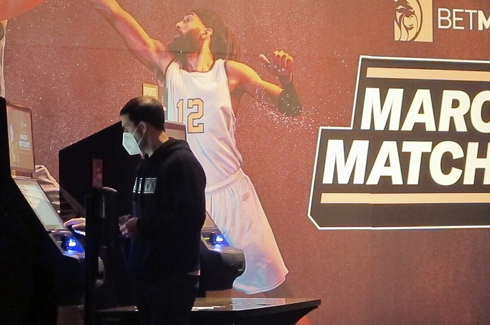 A man makes a bet at a kiosk in the Borgata casino in Atlantic City NJ on March 19, 2021 at the start of the March Madness college basketball tournament. (Wayne Parry/AP, File)