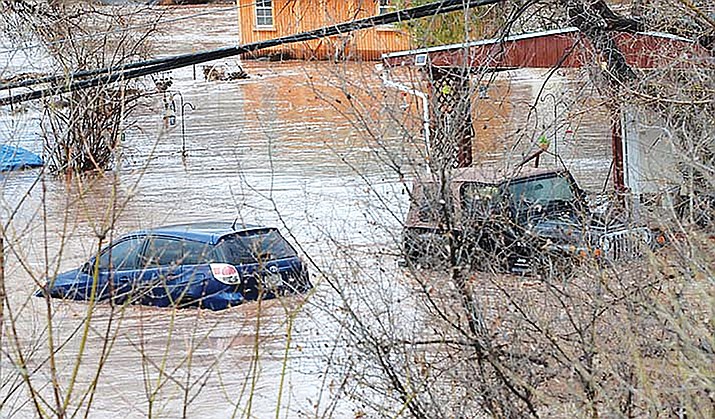 Vehicles lay submerged in flood waters in the Verde Valley last week. (Vyto Starniskas/WGCN)
