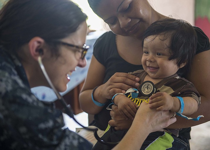 After three years in the pandemic, when they were prohibited from dropping people from Medicaid rolls, Arizona officials have started to review recipients and drop those who no longer qualify. But they said they are working to steer people to other coverage. In this 2015 photo, Navy Lt. Cmdr. Melissa Buryl checks the vitals of a baby in Belize. (Seaman Spc. Kameren Guy Hodnett/U.S. Navy via Cronkite News)
