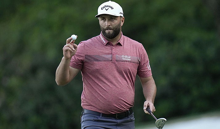 Jon Rahm, of Spain, waves after his putt on the 13th hole during the final round of the Masters golf tournament at Augusta National Golf Club on Sunday, April 9, 2023, in Augusta, Ga. (AP Photo/Jae C. Hong)