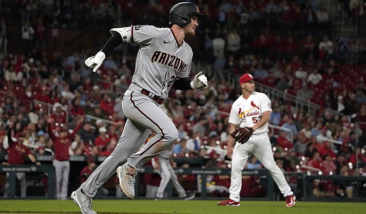 Arizona Diamondbacks' Pavin Smith, left, rounds the bases after hitting a grand slam off St. Louis Cardinals starting pitcher Andre Pallante, right, during the seventh inning of a baseball game Monday, April 17, 2023, in St. Louis. (AP Photo/Jeff Roberson)
