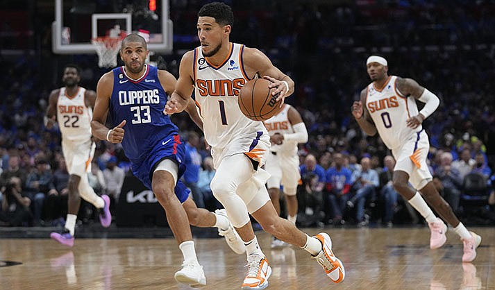 Phoenix Suns guard Devin Booker (1) controls the ball during the second half of Game 3 of a first-round NBA basketball playoff series against the Los Angeles Clippers in Los Angeles, Thursday, April 20, 2023. (AP Photo/Ashley Landis)