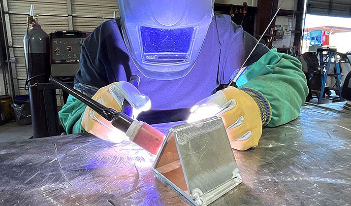 Mingus Union High School student Tuff Morgan welds at Southwest Tank and Steel Inc., where he works part-time, on Wednesday, April 19, 2023. (VVN/Vyto Starinskas)
