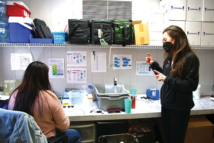 Kimberly Belone and Reese Cuddy stand inside the laboratory in the Johns Hopkins Center for Indigenous Health office in the Fort Defiance agency of the Navajo Nation Feb. 1. This is where the compartment bags are prepped with chemicals and inspected. (Photo/Emma VandenEinde)
