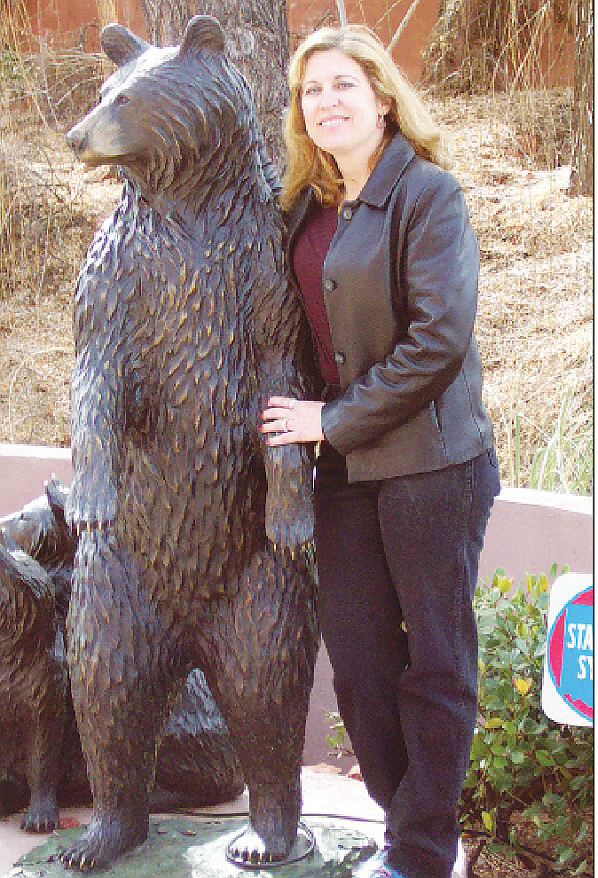 Artist Diana Simpson with a bronze statue of black bears that she sculpted. (Diana Simpson/Courtesy)
