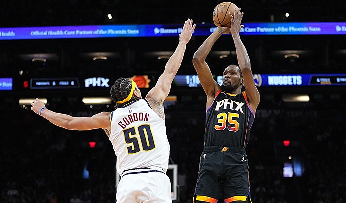 Phoenix Suns forward Kevin Durant (35) shoots over Denver Nuggets forward Aaron Gordon (50) during the first half of Game 4 of an NBA basketball Western Conference semifinal game, Sunday, May 7, 2023, in Phoenix. (AP Photo/Matt York)