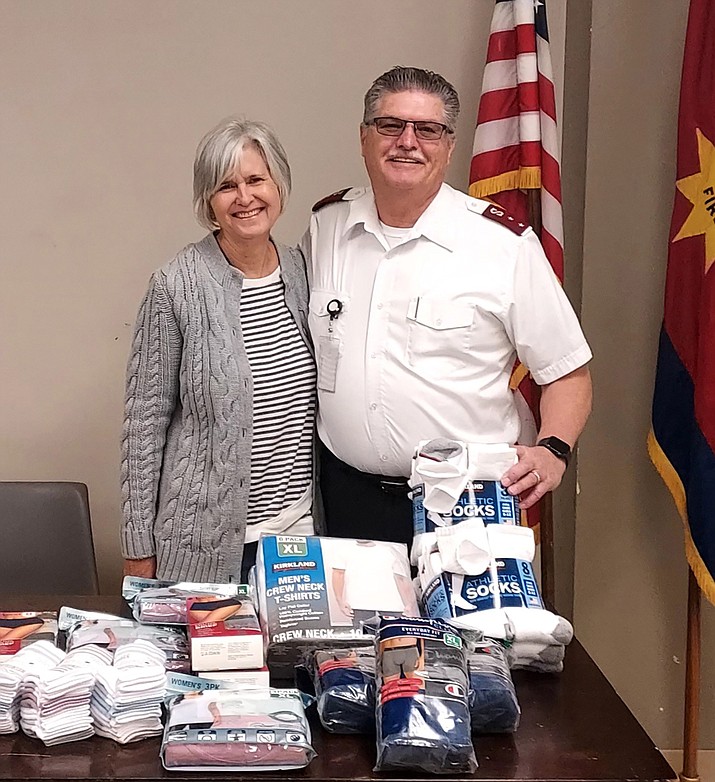 Captain Tony Poe accepts a $260 donation of underwear, socks and T-shirts for the homeless in Prescott. (Courtesy photo)
