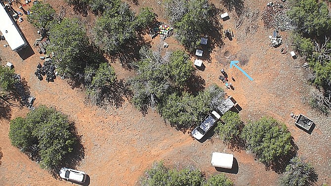 Forensic evidence was recovered on the property including skull fragments in the fire pit indicated by the arrow in this overhead photo. (Yavapai County Sheriff’s Office/Courtesy
