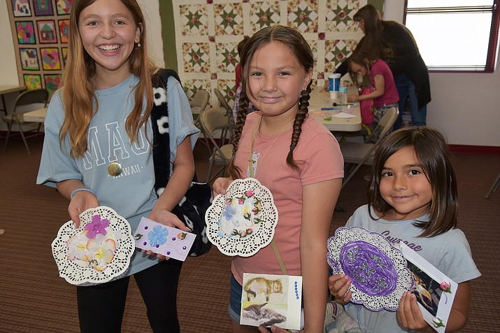 From left, Gianni, 11, Hazel, 10, and Giuliana, 7, show their Mother’s Day crafts that they made at the Chino Valley Public Library on Friday, May 5, 2023. (Jesse Bertel/Review)