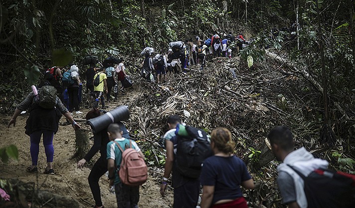Migrants walk across the Darien Gap from Colombia to Panama in hopes of reaching the U.S., Tuesday, May 9, 2023. Pandemic-related U.S. asylum restrictions, known as Title 42, are to expire Thursday, May 11. (AP Photo/Ivan Valencia)