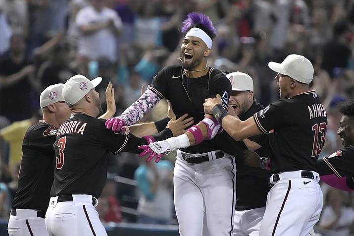 Arizona Diamondbacks' Lourdes Gurriel Jr., center, celebrates with teammates after hitting a walkoff double in the ninth inning during a game against the San Francisco Giants, Sunday, May 14, 2023, in Phoenix. (Rick Scuteri/AP)