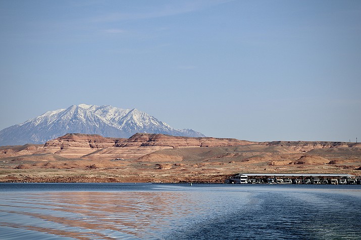 Boats sit in Lake Powell, the nation’s second-largest reservoir, which relies in part on snowmelt from the Rocky Mountains. As water reserves have shrunk, scientists have started to study the gap between snowfall and runoff. (Photo by Alex Hager/KUNC)