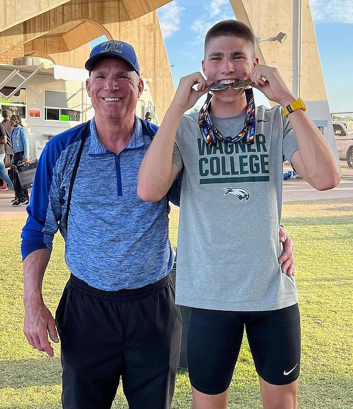 Prescott track and field athlete Jack Mason, right, shows off his medal with his father Todd Mason after winning the triple jump event during the Open State Championship on Saturday, May 12, 2023, at Mesa Community College. (Prescott track and field/Courtesy)