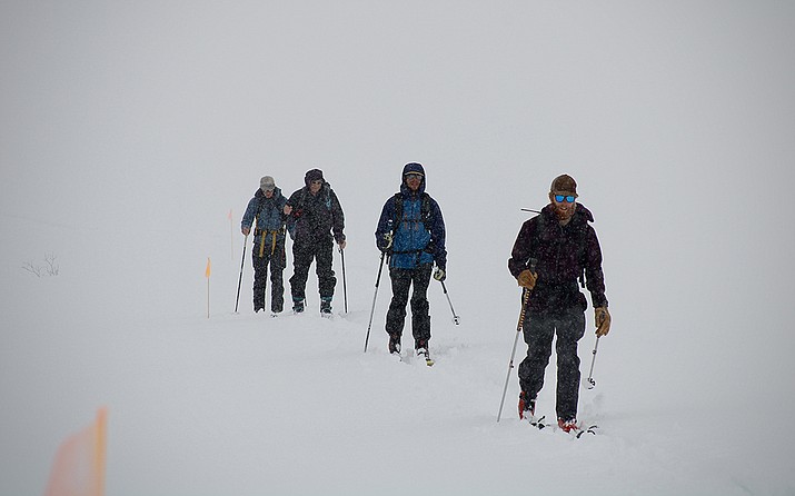From right, Danny Hogan and Eli Schwat lead a trek toward a snow research site on March 15, 2023. They gather data on snow from nearly 10,000 feet above sea level, helping to add more detail to forecasts of Colorado River water supply. (Alex Hager/KUNC)