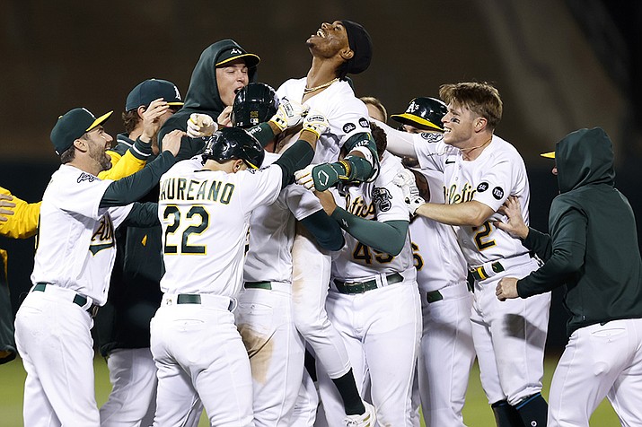 Oakland Athletics' Esteury Ruiz, center, celebrates with teammates after a game winning single during the 12th inning of a baseball game against the Arizona Diamondbacks in Oakland, Calif., Tuesday, May 16, 2023. (Jed Jacobsohn/AP)