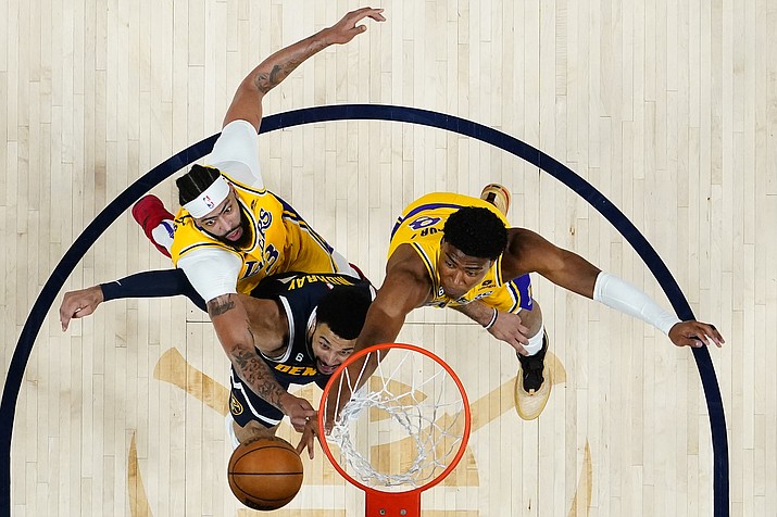 Denver Nuggets guard Jamal Murray, center, rebounds against Los Angeles Lakers forward Anthony Davis, left, and forward Rui Hachimura during the first half of Game 2 of the Western Conference Finals series, Thursday, May 18, 2023, in Denver. (Jack Dempsey/AP)