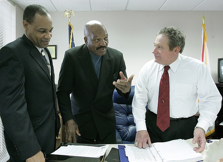 Jim Brown, Pro Football League Hall of Fame running back, actor, and activist, center, talks with Rep. Mitch Needelman, R-Melbourne, chairman of the House committee on juvenile justice, right, and Walt McNeil, Secretary of the Department of Juvenile Justice, left, prior to the meeting of the committee, Wednesday, Feb. 21, 2007, in Tallahassee, Fla. Brown addressed the committee regarding gang intervention and prevention. NFL legend, actor and social activist Jim Brown passed away peacefully in his Los Angeles home on Thursday night, May 18, 2023, with his wife, Monique, by his side, according to a spokeswoman for Brown's family. He was 87. (Phil Coale, AP File)