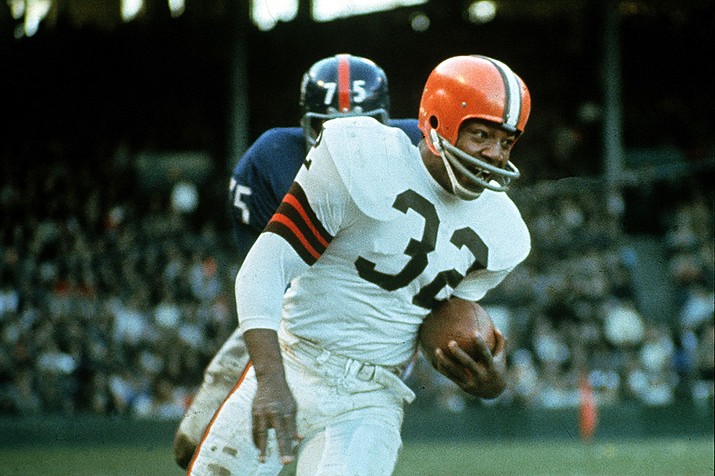 Jimmy Brown (32), running back for the Cleveland Browns, is shown in action against the New York Giants in Cleveland, Ohio, on Nov. 14, 1965. NFL legend, actor and social activist Jim Brown passed away peacefully in his Los Angeles home on Thursday night, May 18, 2023, with his wife, Monique, by his side, according to a spokeswoman for Brown's family. He was 87. (AP File)