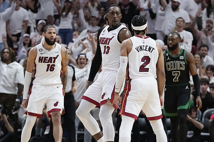 Miami Heat center Bam Adebayo (13) reacts guard Gabe Vincent (2) three-point shot during the second half of Game 3 of the NBA basketball playoffs Eastern Conference finals against the Boston Celtics, Sunday, May 21, 2023, in Miami. (Wilfredo Lee/AP)