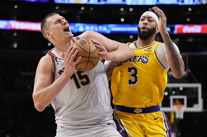Denver Nuggets center Nikola Jokic (15) is defended by Los Angeles Lakers forward Anthony Davis (3) in the second half of Game 4 of the Western Conference Final series Monday, May 22, 2023, in Los Angeles. (Ashley Landis/AP)