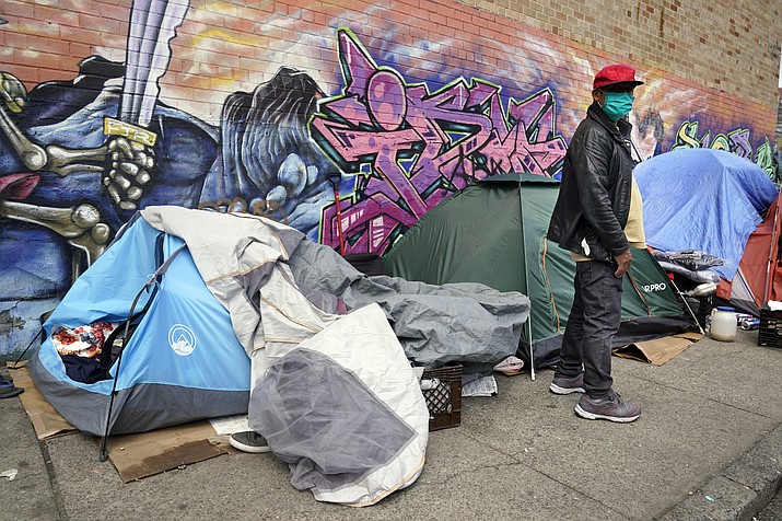 Sotero Cirilo stands near the tent where he sleeps next to other homeless people in the Queens borough of New York on April 14, 2021. The City Council unanimously approved a “Homeless Bill of Rights” in April 2023 that would make New York the first big U.S. city to establish an explicit right to sleep in at least some public places. If Mayor Eric Adams, a Democrat, allows the measure to become law, it could be a notable departure for the city — which has for years sent police and sanitation crews to clear homeless encampments as they arise. (Seth Wenig/AP, File)