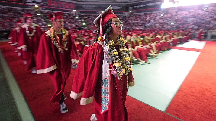 Amryn Tom graduates from Cedar City High School on Wednesday, May 25, 2022, in Cedar City, Utah. Tom is wearing an eagle feather given to her by her mother and a cap that a family friend beaded. (Rick Bowmer/AP, File)