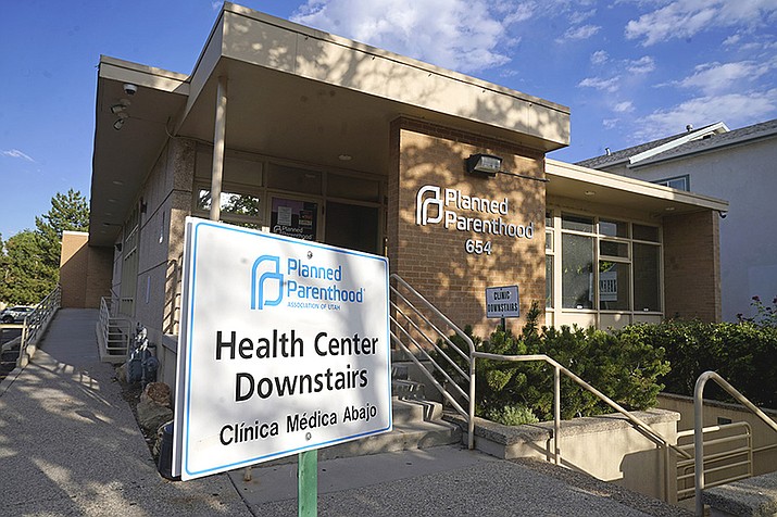 A sign stands outside Planned Parenthood of Utah on June 28, 2022, in Salt Lake City. Planned Parenthood is shifting funding to its state affiliates and cutting national office staff to reflect a changed landscape in both how abortion is provided and how battles over access are playing out. The group, a major provider of abortion and other health services and also an advocate for abortion access, told its staff on Monday, May 22, 2023, that layoff notices would go out in June and provided The Associated Press with an overview Tuesday. (Rick Bowmer/AP, File)