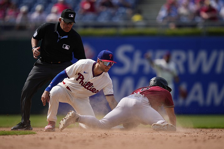 Philadelphia Phillies shortstop Trea Turner, center, tags out Arizona Diamondbacks’ Dominic Fletcher, right, after he tried to steal second during the eighth inning of a game, Wednesday, May 24, 2023, in Philadelphia. (Matt Slocum/AP)