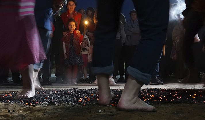 Firewalkers dance across a bed of burning coals in a ritual in honor of St. Constantine in the village of Lagkadas, Greece on Monday, May 22, 2023. Firewalking is the most spectacular and public of these annual rituals that also include dancing with icons, prayer, and shared meals by associations of devotees of the Christian Orthodox saint called "anastenaria" that have held similar celebrations for centuries. (AP Photo/Giovanna Dell'Orto)