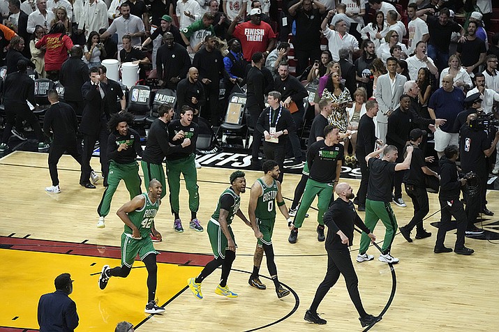 Boston Celtics players celebrate after the Celtics beat the Miami Heat 104-103 during Game 6 of the NBA basketball Eastern Conference finals, Saturday, May 27, 2023, in Miami. (Rebecca Blackwell/AP)