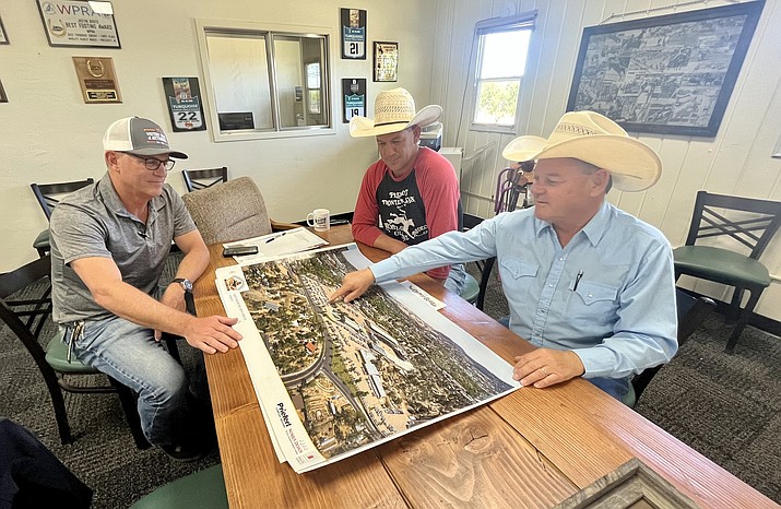 Prescott Frontier Days, Inc. officials Greg Mengarelli, business development manager, left, Jim Dewey Brown, general manager, center, and Ron Owsley, president, look at the master plan for a $40 million improvement/expansion that has been proposed for the Prescott Rodeo Grounds. The three met on Friday, May 26, 2023, to talk about the plans for improvements and the recently approved $15.3 million allocation from the state of Arizona. (Cindy Barks/Courier)