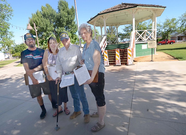 Cynthia Malla, Tommie Bain, Amanda Arnold and Jason Benatz, right to left, hold petitions that state that the Clarkdale bandstand should be preserved and not demolished. (VVN/Vyto Starinskas)